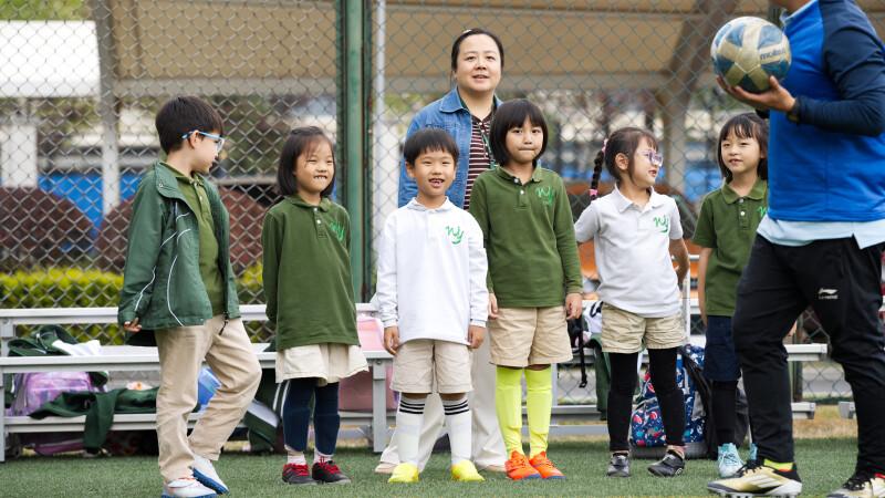 Group of elementary students at Wuhan Yangtze International School participating in after-school soccer club.