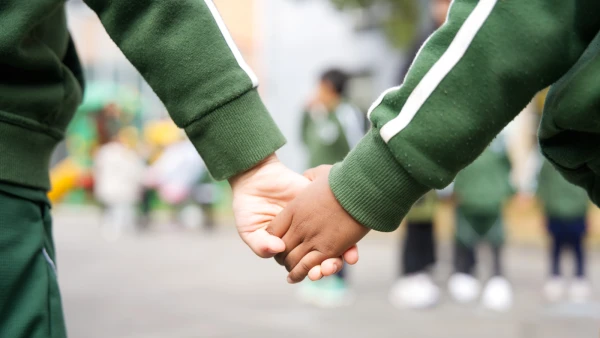 Two students in the Early Childhood Center (ECC) holding hands at Wuhan Yangtze International School.