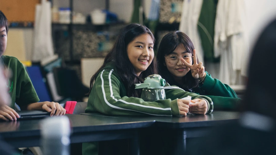 two smiling female students at wuhan yangtze international school